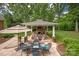 Backyard patio with outdoor dining and a fireplace underneath a pergola at 12048 Royal Portrush Dr, Charlotte, NC 28277