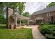 Backyard patio with outdoor seating and a brick home at 12048 Royal Portrush Dr, Charlotte, NC 28277