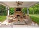 Backyard patio with outdoor seating and a fireplace underneath a pergola at 12048 Royal Portrush Dr, Charlotte, NC 28277