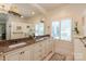 Bathroom featuring double sinks, brown marble counter tops, and custom cabinetry at 12048 Royal Portrush Dr, Charlotte, NC 28277