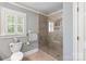 Bathroom showing tiled shower with glass door at 12048 Royal Portrush Dr, Charlotte, NC 28277
