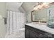 Bathroom features a dark vanity, marble countertops, and a shower with a patterned curtain at 12048 Royal Portrush Dr, Charlotte, NC 28277