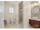 Modern bathroom featuring glass shower, pedestal sink, tiled flooring, and decorative lighting at 12048 Royal Portrush Dr, Charlotte, NC 28277