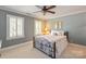 Comfortable bedroom featuring neutral paint, ceiling fan, and plenty of natural light at 12048 Royal Portrush Dr, Charlotte, NC 28277