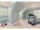 Spacious bonus room with sloped ceilings, neutral paint, and exercise equipment at 12048 Royal Portrush Dr, Charlotte, NC 28277