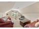 Upstairs bonus room with comfortable couches and a large window at 12048 Royal Portrush Dr, Charlotte, NC 28277
