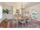 Formal dining room featuring a chandelier, wainscoting, and hardwood floors at 12048 Royal Portrush Dr, Charlotte, NC 28277