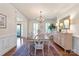 Formal dining room featuring a chandelier, wainscoting, and hardwood floors at 12048 Royal Portrush Dr, Charlotte, NC 28277