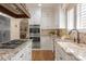 Well-equipped kitchen featuring custom cabinets, stainless appliances, and granite countertops at 12048 Royal Portrush Dr, Charlotte, NC 28277