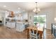 Bright kitchen features white cabinetry, stainless steel appliances, and a breakfast area at 12048 Royal Portrush Dr, Charlotte, NC 28277