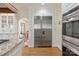 Bright kitchen featuring stainless steel refrigerator, granite countertops, hardwood flooring, and white cabinets at 12048 Royal Portrush Dr, Charlotte, NC 28277