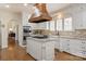 Gourmet kitchen with a large island, modern appliances, and a custom range hood at 12048 Royal Portrush Dr, Charlotte, NC 28277