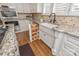 A kitchen with custom cabinets, stone countertops, stainless appliances, farmhouse sink, and a spice rack pull out at 12048 Royal Portrush Dr, Charlotte, NC 28277