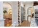 Bright kitchen with custom cabinets, stone countertops, stainless steel fridge, and pull-out shelving at 12048 Royal Portrush Dr, Charlotte, NC 28277
