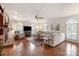 Spacious living room with a ceiling fan, plantation shutters, fireplace, and a large sectional sofa at 12048 Royal Portrush Dr, Charlotte, NC 28277