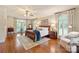 Spacious primary bedroom featuring hardwood floors, large windows, and elegant furnishings at 12048 Royal Portrush Dr, Charlotte, NC 28277