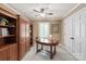 Office with built-in shelving, ceiling fan, and plenty of natural light at 12048 Royal Portrush Dr, Charlotte, NC 28277