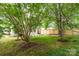 Grassy backyard featuring trees, a patio, and the exterior of the house at 1208 Tarrington Ave, Charlotte, NC 28205