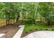 Landscaped backyard featuring a well-maintained lawn, patio, and privacy fence at 1208 Tarrington Ave, Charlotte, NC 28205