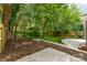 Private backyard featuring a well-maintained lawn, landscaping, and a patio at 1208 Tarrington Ave, Charlotte, NC 28205
