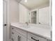 Modern bathroom with white cabinets, sleek fixtures, and a large mirror at 1208 Tarrington Ave, Charlotte, NC 28205