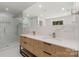 Modern bathroom with double sink vanity, marble backsplash, and glass shower at 1208 Tarrington Ave, Charlotte, NC 28205