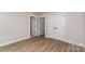 Bright bedroom featuring wood floors, neutral walls, and ample closet space at 1208 Tarrington Ave, Charlotte, NC 28205