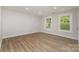 Light-filled bedroom with wood floors, a bright window, and neutral wall paint at 1208 Tarrington Ave, Charlotte, NC 28205