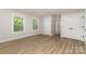 Bedroom featuring light wood floors, closet storage, and two windows at 1208 Tarrington Ave, Charlotte, NC 28205