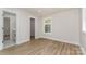 Bedroom featuring wood floors, neutral walls, and an adjoining bathroom at 1208 Tarrington Ave, Charlotte, NC 28205