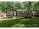 Charming home featuring a lush front yard, fresh landscaping, and a welcoming entrance at 1208 Tarrington Ave, Charlotte, NC 28205