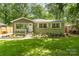 Charming home featuring a lush front yard, fresh landscaping, and a welcoming entrance at 1208 Tarrington Ave, Charlotte, NC 28205