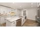 Bright kitchen boasts an island with stainless steel dishwasher and marble countertops at 1208 Tarrington Ave, Charlotte, NC 28205