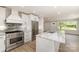 Modern kitchen features stainless steel appliances, island, and marble countertops at 1208 Tarrington Ave, Charlotte, NC 28205