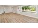 Bright living room with wood floors and a large window showcasing a street view at 1208 Tarrington Ave, Charlotte, NC 28205