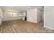 Spacious living room featuring wood floors and an open layout with a view of the kitchen at 1208 Tarrington Ave, Charlotte, NC 28205