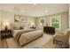 Staged main bedroom featuring a large bed, natural light, and neutral décor at 1208 Tarrington Ave, Charlotte, NC 28205