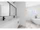Bathroom featuring double vanity, modern fixtures, and soaking tub for relaxation at 13109 Homewood Dr, Charlotte, NC 28262