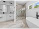 Modern bathroom featuring a soaking tub, glass enclosed shower, and double vanity sinks at 13109 Homewood Dr, Charlotte, NC 28262