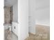 View into bathroom featuring tile, a shower-tub, vanity, and shelves at 13109 Homewood Dr, Charlotte, NC 28262