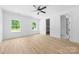 Sunlit bedroom features two windows, ceiling fan, and an ensuite bathroom at 13109 Homewood Dr, Charlotte, NC 28262