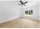 Bright bedroom features hardwood floors and a ceiling fan with a large window at 13109 Homewood Dr, Charlotte, NC 28262