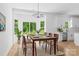 Bright dining area with large windows, wood table with seating for six, and modern lighting fixture at 13109 Homewood Dr, Charlotte, NC 28262