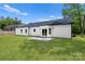 Well-maintained home exterior with white siding, a dark roof, and a private backyard at 13109 Homewood Dr, Charlotte, NC 28262