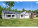 New home boasts a manicured lawn, dual garage, with a classic white and black color scheme at 13109 Homewood Dr, Charlotte, NC 28262