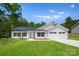 Beautiful new construction home featuring manicured lawn, 2-car garage, and classic white color scheme at 13109 Homewood Dr, Charlotte, NC 28262