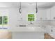 Well-lit kitchen featuring an island, stainless appliances, and white cabinetry at 13109 Homewood Dr, Charlotte, NC 28262