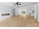 Spacious living room boasting an open floor plan, modern fireplace, hardwood floors, and ample natural light at 13109 Homewood Dr, Charlotte, NC 28262