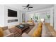 Bright living room boasts a fireplace, ceiling fan, and neutral decor throughout the open floor plan at 13109 Homewood Dr, Charlotte, NC 28262