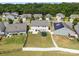 Aerial view of a fenced backyard, green lawn, and trampoline, in a residential neighborhood at 13315 Hunting Birds Ln, Charlotte, NC 28278